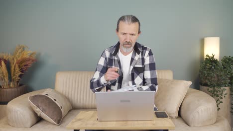 Man-making-video-call-on-laptop.